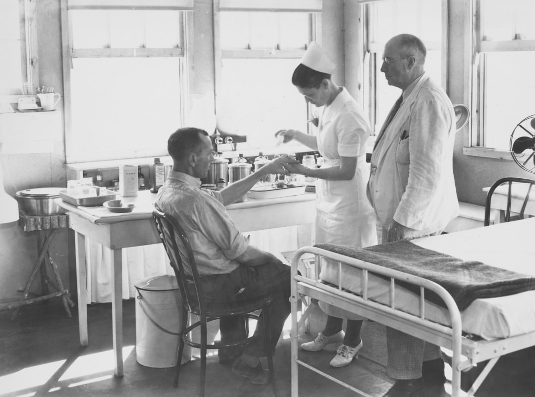 hospital therapy dog — Nurse attends to patient with doctor observing